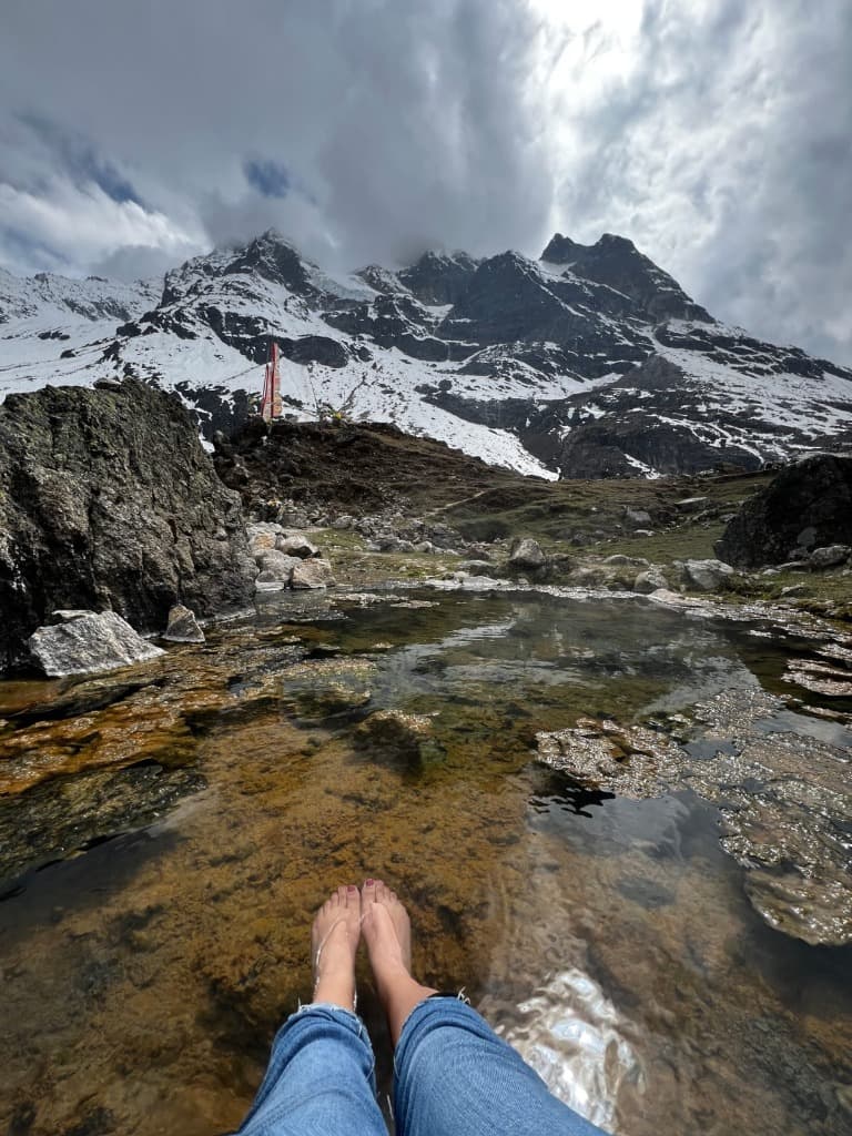 Crystal clear mountain stream with snow peaks